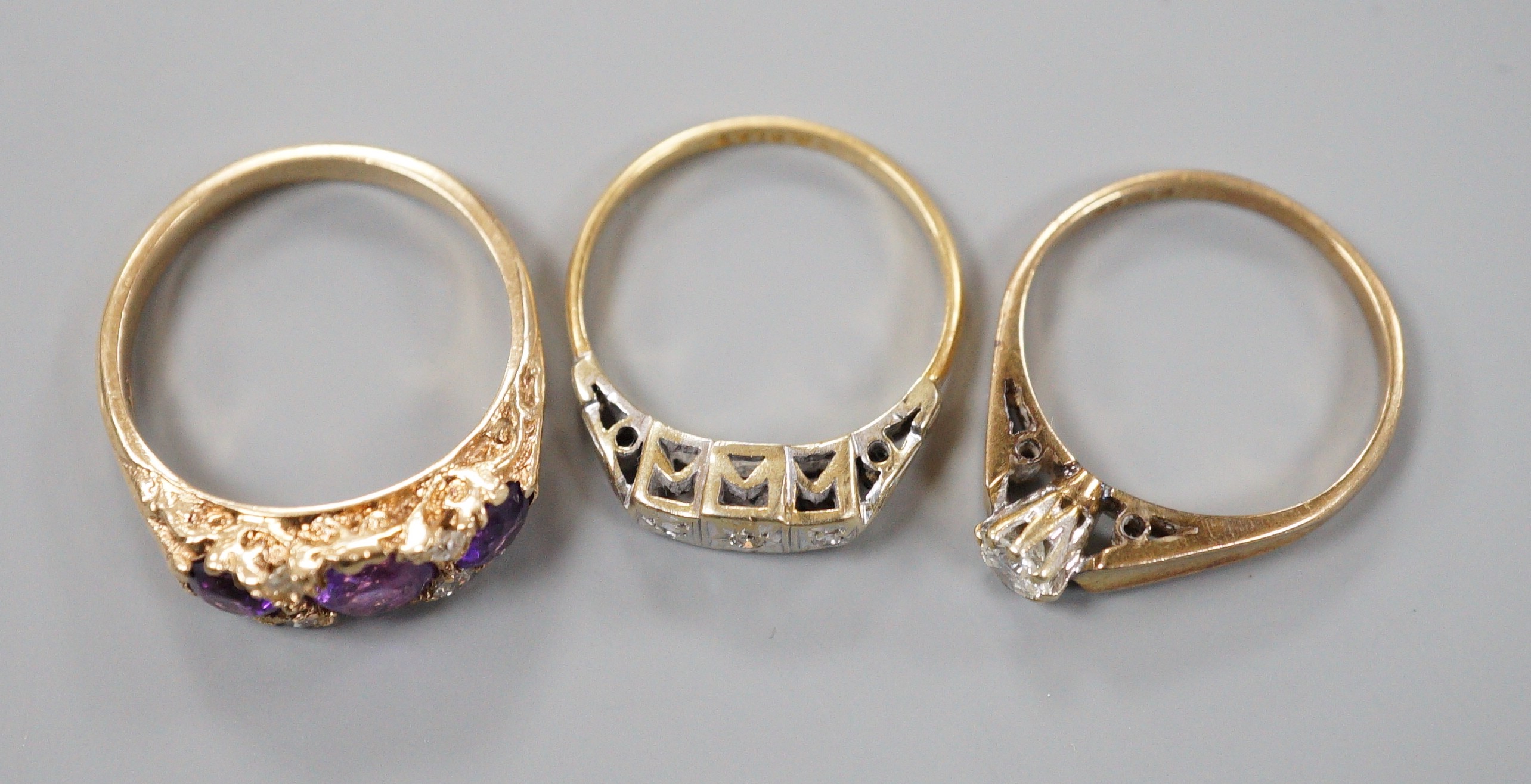 An 18ct and illusion set three stone diamond ring, gross 2.8 grams and two 9ct and gem set rings including amethyst and diamond chip half hoop, gross 5.2 grams.